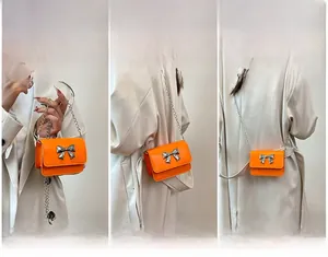 Three-way view of bright orange mini bag with silver bow buckle worn as crossbody and shoulder
