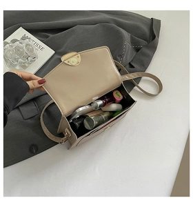 Vue interne du sac à rabat beige montrant sa capacité pour téléphone et maquillage