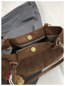 Detailed top view of dark brown quilted tote bag showing double magnetic closures