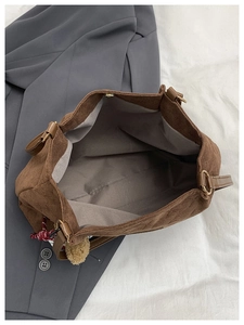 Detail of brown corduroy tote bag showing large capacity interior and quilted texture