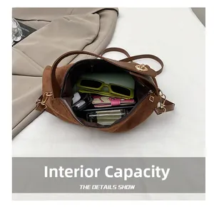 Interior view showing large storage capacity of the brown suede handbag for daily items
