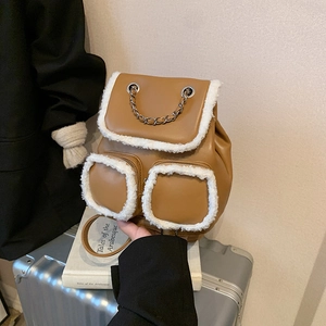 Brown faux leather backpack with white shearling trim and decorative silver chain handle