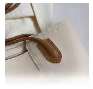 Close-up of precise stitching and premium leather contrast on fashion tote bag
