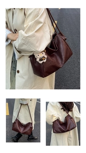 Detail of vintage brown leather tote bag with RICHAD engraving and plush cat pendant