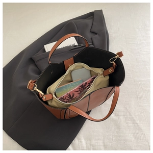 Top view of two-tone tote bag interior showing capacity for phone and wallet with inner pouch
