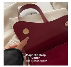 Detailed close-up of the wine red saddle bag featuring a double magnetic snap closure system