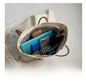 Top-down view of spacious tote bag interior with compartments holding tablet and essentials