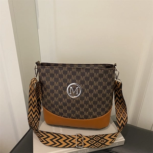 Chic monogram patchwork shoulder bag with bohemian strap and metallic M logo