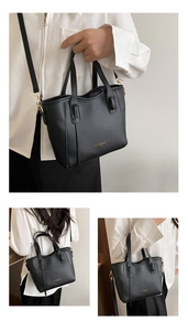 Detail of black leather bucket bag with gold hardware and adjustable strap options