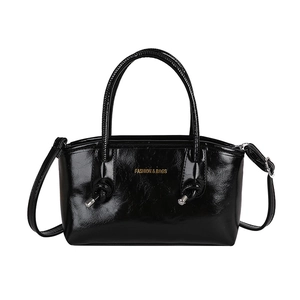 Fashionable black glossy leather tote bag for women with dual handles and crossbody strap