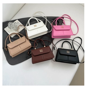 Detail of five mini square leather bags in white, pink, khaki, brown, and black colors