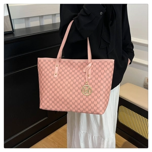 Detailed view of pink tote bag with M-letter monogram print and gold metal pendant