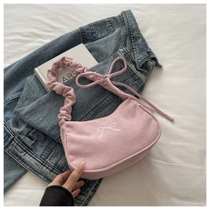 Pink corduroy shoulder bag with white bow embroidery and scrunchie handle detail