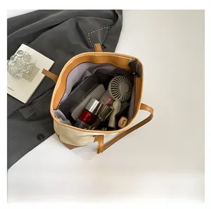 Interior view showing large capacity storage for tablets and cosmetics in tote bag