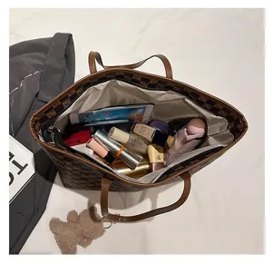 Top view of spacious checkerboard tote bag interior showing iPad and essentials