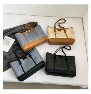 Detailed view of four felt tote bags in various color combinations on a white background