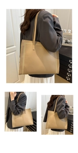 Détail d'un sac cabas en cuir grainé avec de fines lanières et bordure décorative