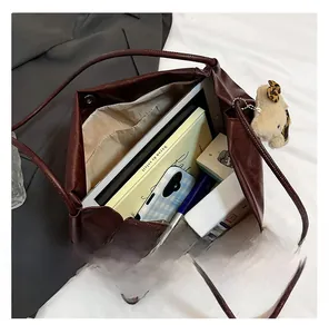 Macro view of spacious interior in burgundy faux leather tote showing large capacity