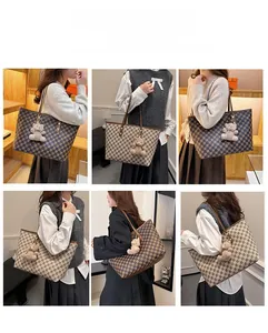 Detail of classic patterned tote bag with bear charm and long adjustable shoulder strap