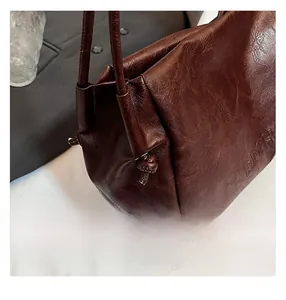Detailed macro view of brown vintage tote bag with RDCH embossing and knotted leather strap