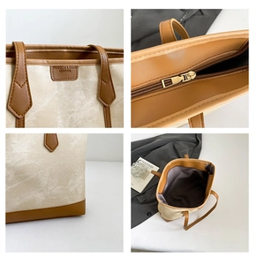 Detail view of canvas tote bag showing zipper closure and leather stitching craftsmanship