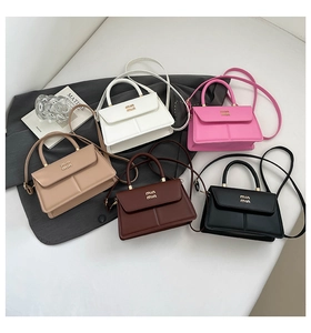 Top view of mini flap crossbody bags in five colors with round handles and metal logo