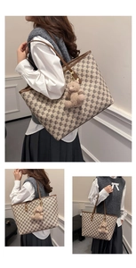 Detail of printed tote bag featuring brown geometric patterns and cute teddy bear charm