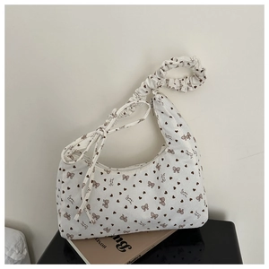 Détail du sac bandoulière en velours blanc avec motifs nœuds et poignée plissée