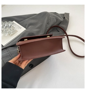 Top view of wine red leather flap bag with gold locks and slim shoulder strap