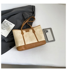Macro shot of minimalist tote bag with marble texture canvas and brown leather details