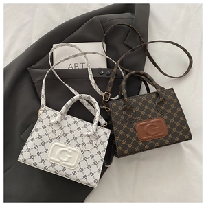 Close-up of mini tote bags in floral and monogram patterns with embossed G logo