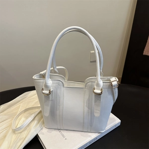 Elegant white tote bag with textured synthetic leather and gold rings for women
