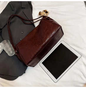 Detailed view of the vintage dark brown wax leather texture and RDCHAID embossed logo