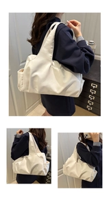Detail of off-white pleated tote bag showing soft texture and wide shoulder strap