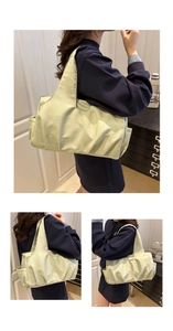 Detail of light green pleated shoulder bag showing side pocket and silky texture nylon