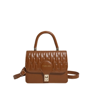 Brown quilted leather handbag with gold metal clasp and adjustable shoulder strap for women