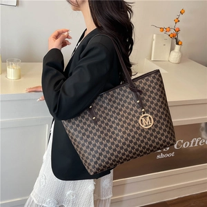 Brown monogram tote bag with letter print and metal pendant for office commute