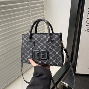Fashionable black crossbody bag with geometric chain print and large G logo detail