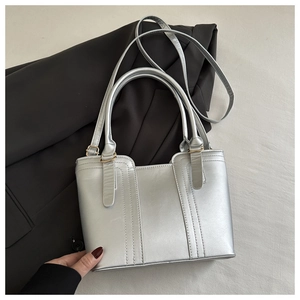 Silver metallic bucket handbag with top handles and adjustable shoulder strap for women