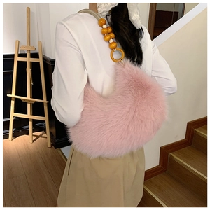 Pink faux fur crescent underarm bag with unique wooden bead shoulder strap detail