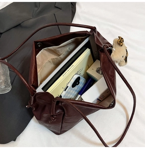 Spacious dark brown tote bag showing capacity for a tablet, books, and daily essentials