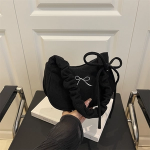 Fashionable black corduroy pleated underarm bag with embroidered silver bow detail