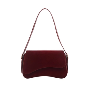 Burgundy faux suede saddle bag with asymmetric curved flap and slim shoulder strap