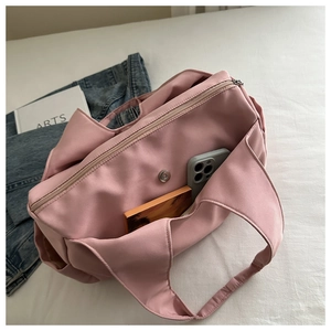 Pink pleated nylon tote bag showing spacious interior for books and mobile phone