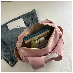 Top view of pink pleated tote bag interior showing spacious capacity for books and items