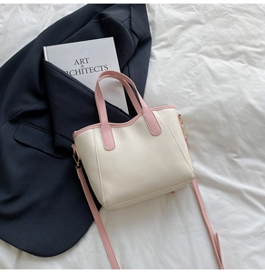 Detail of the cream and pink leather mini bucket bag with gold-tone hardware and strap