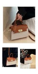 Detail of canvas and brown leather kelly bag with gold clasp and detachable shoulder strap