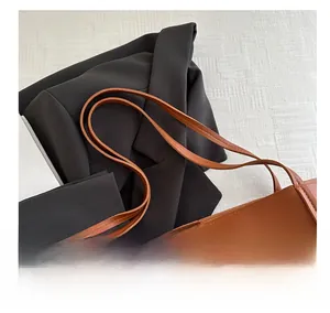 Detail of comfortable carry handle on brown leather tote bag with professional look