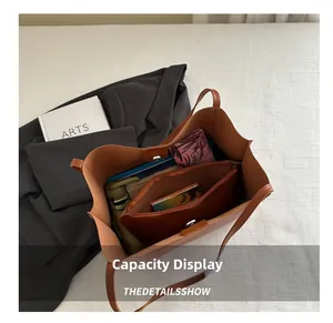 Detailed top view of large brown tote bag showing spacious interior with inner pouch