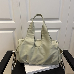 Minimalist light green pleated tote bag with large capacity and integrated shoulder strap